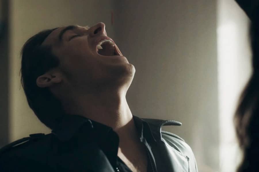 Ramsey leans his head back as blood is dripped into his mouth