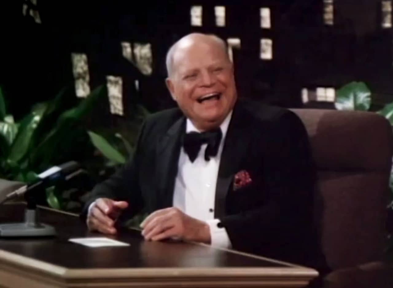 Don Prince laughing at his desk