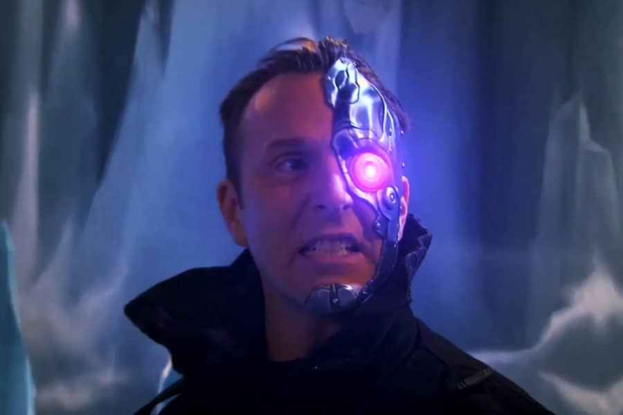 villain with half face of metal and a glowing purple eye