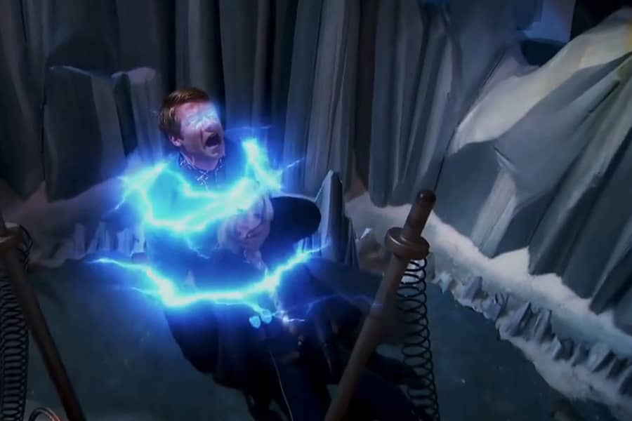 teen boy holding Tess, unconscious, and he’s surrounded by blue electricity and his eyes are glowing blue