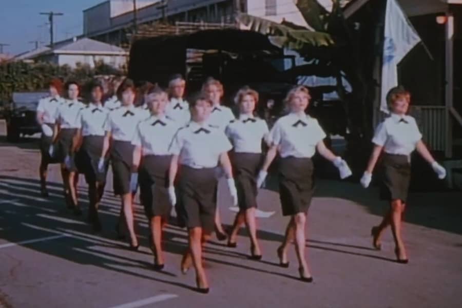 women in uniform walking in formation