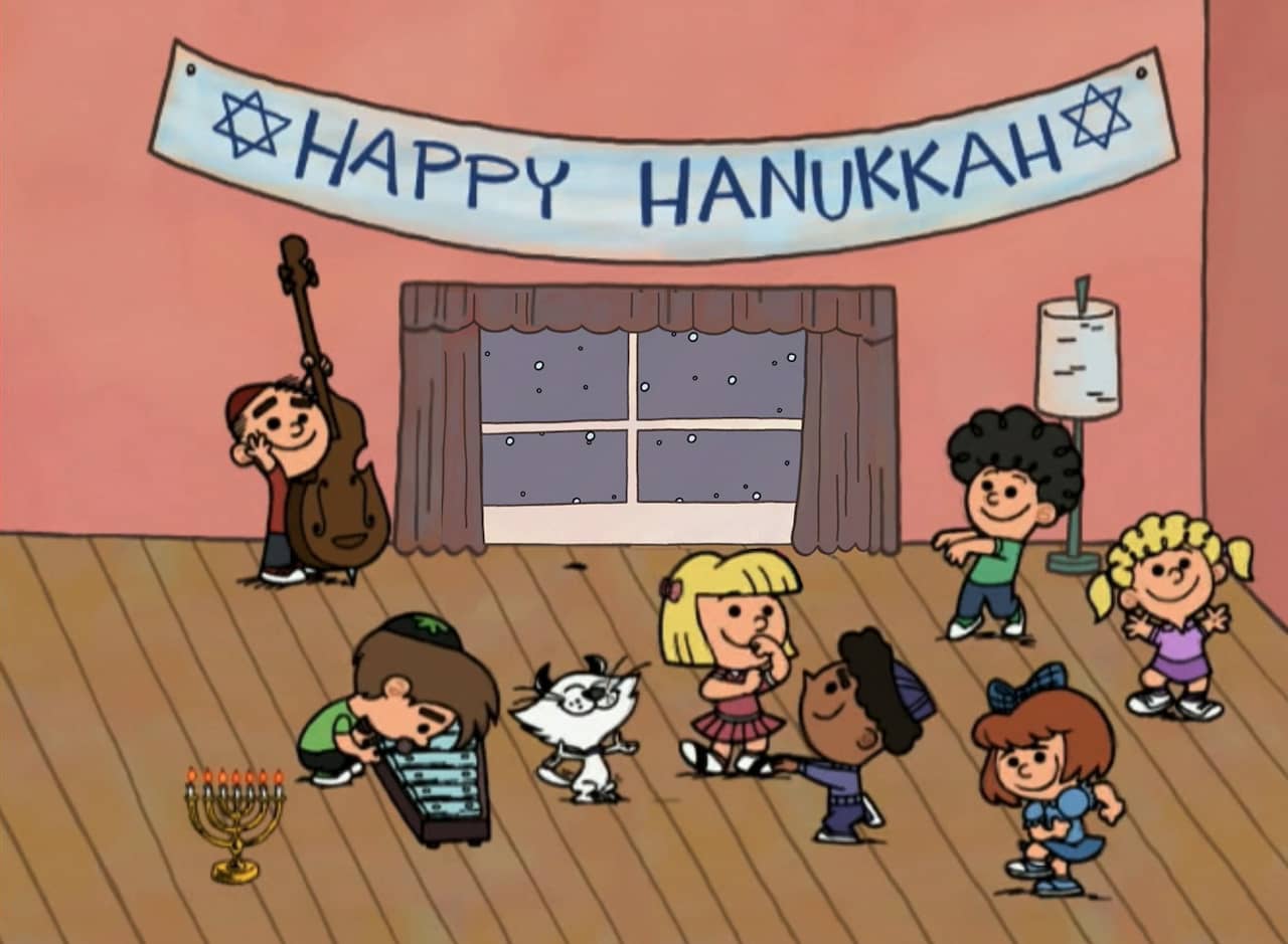 Walnuts kids dancing with a “Happy Hanukkah” banner