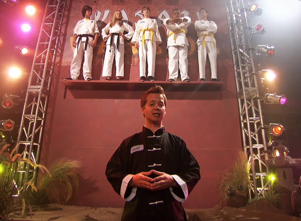 Sensei Rudy and five karate kids up on a high ledge