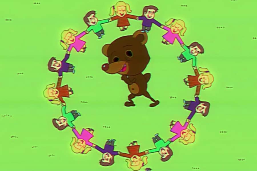 Teddy dancing inside a circle of children
