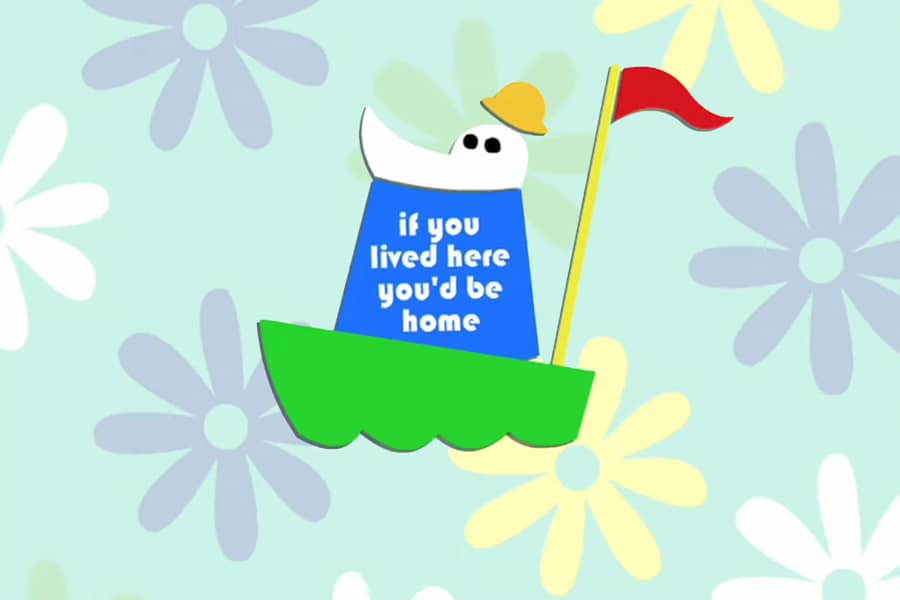 paper cutout version of Homsar in a boat with t-shirt that says, “if you lived here, you’d be home”