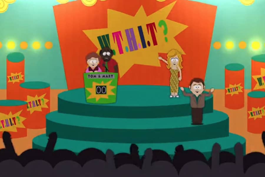 wide shot of the set of the show with the hosts, studio audience, and a couple at a podium