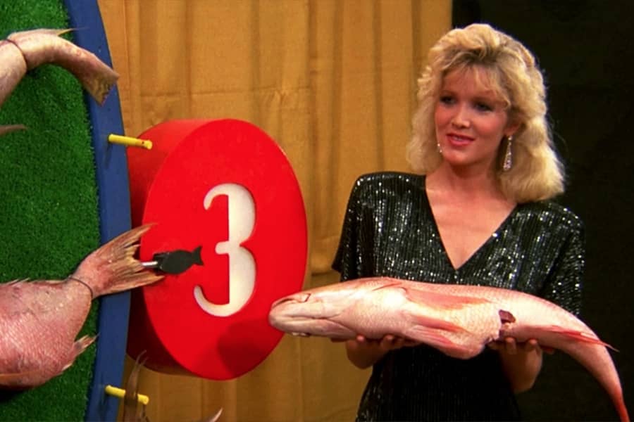 show hostess brings out a giant dead fish