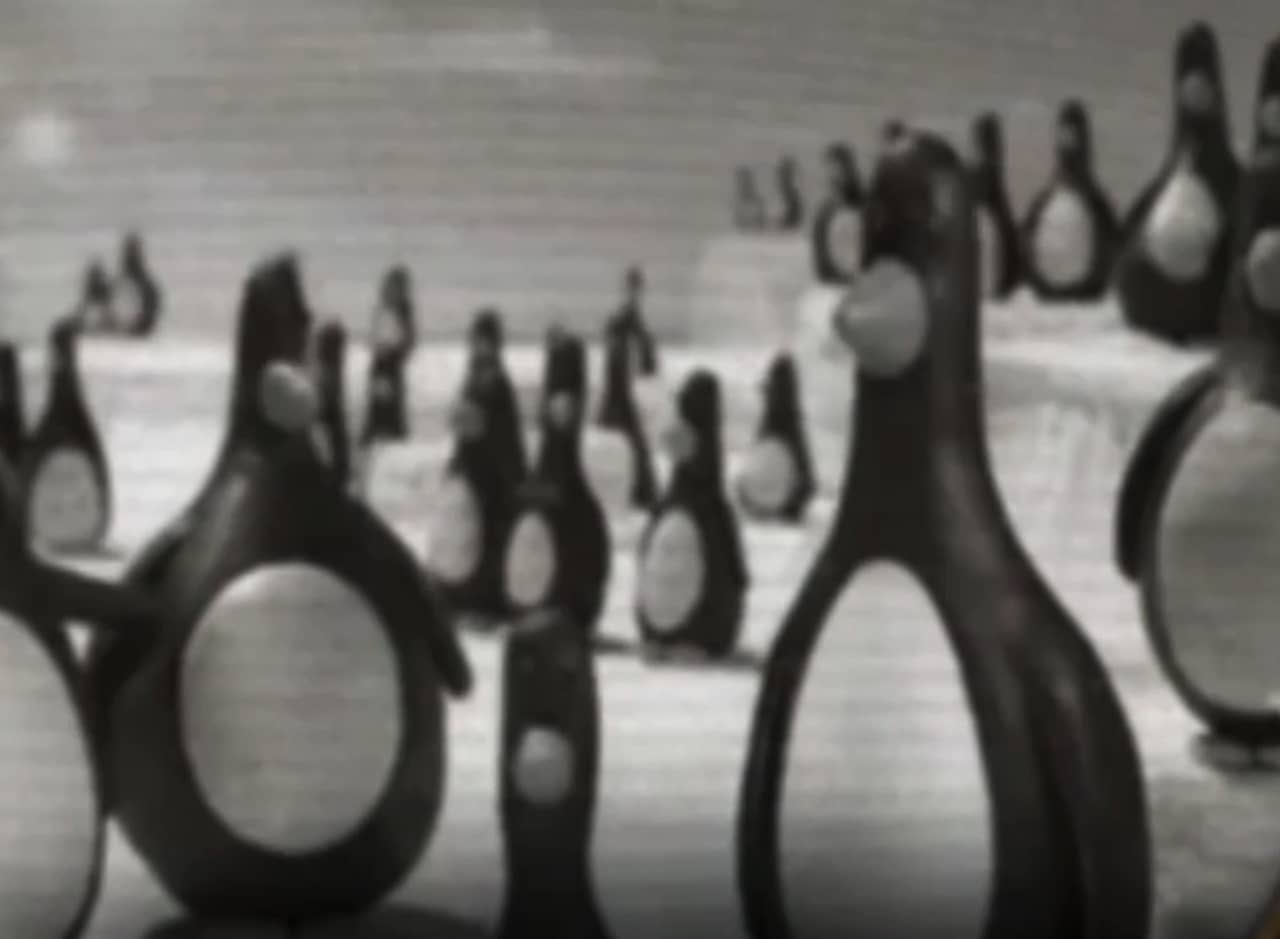 a bunch of penguins sitting on the ice