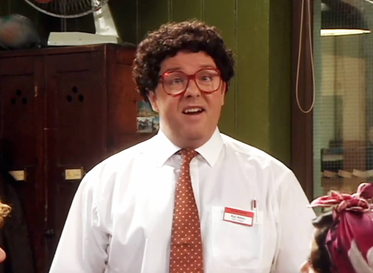 Andy Millman as Ray Stokes, an awkward man with curly hair and large-framed, red glasses