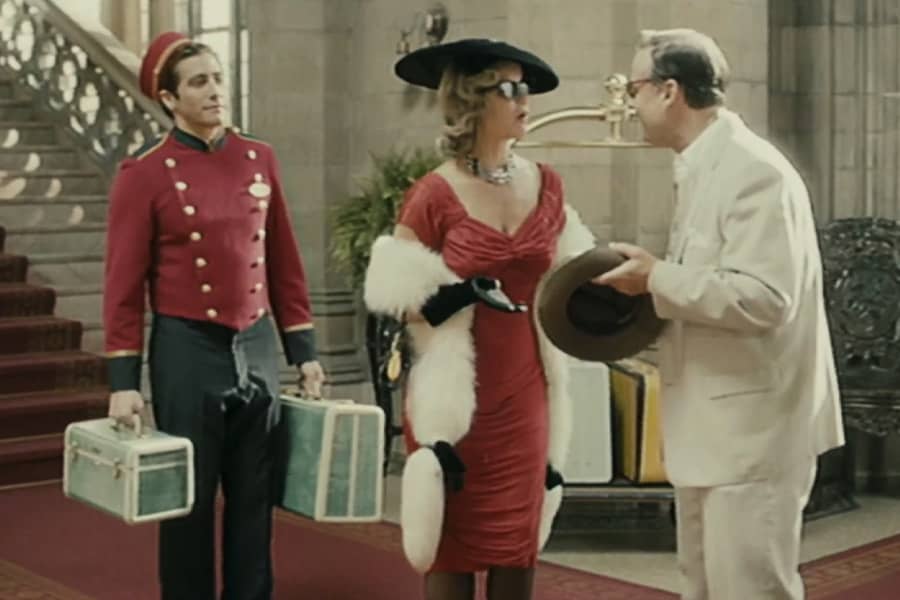 Lipton talks with a man while a bellhop holds her luggage
