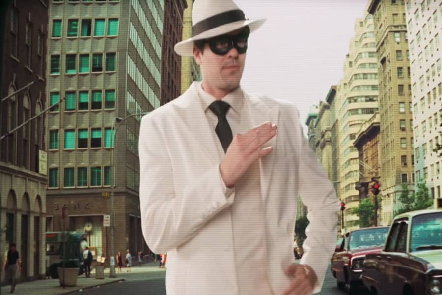 White Hat running down a city street