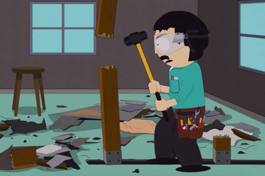 Randy taking a sledge-hammer to a house post