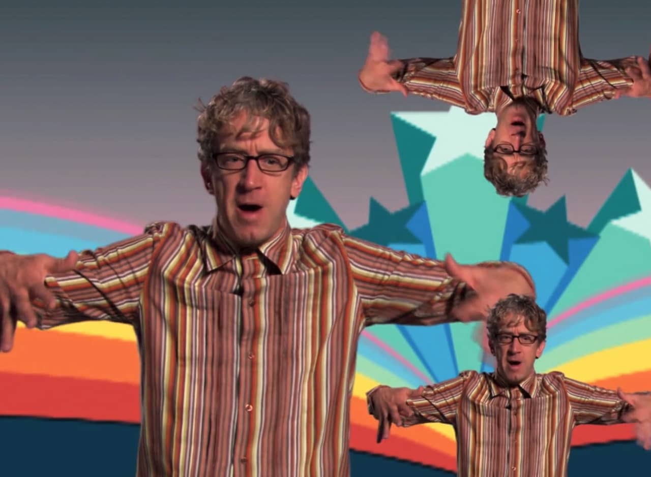 Andy Dick superimposed multiple times (even upside down) on a colorful background