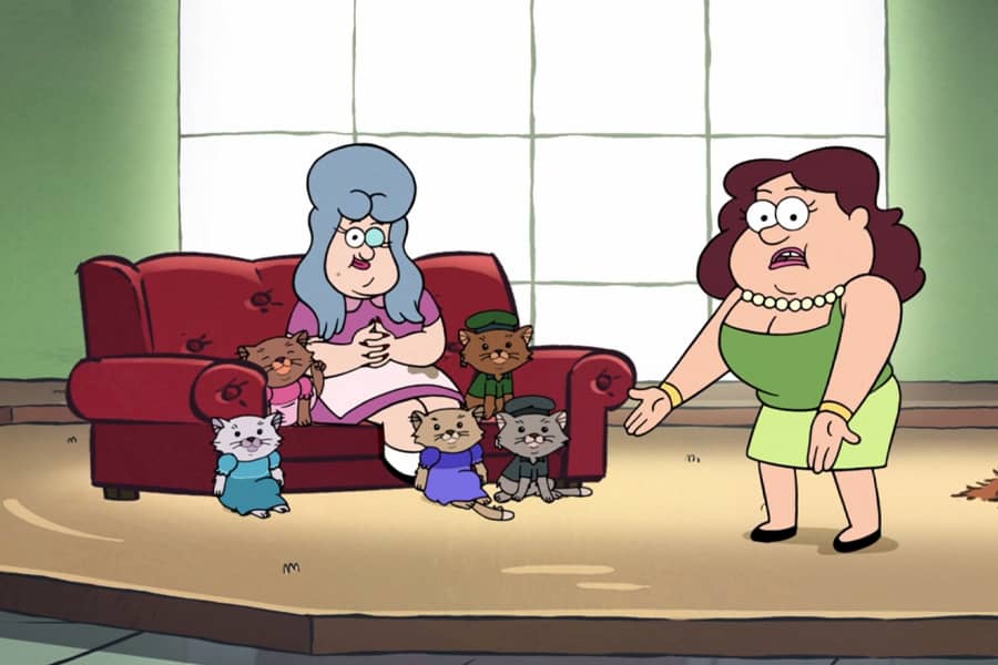 Sassica being sassy with an older woman with five cats dressed in human clothes