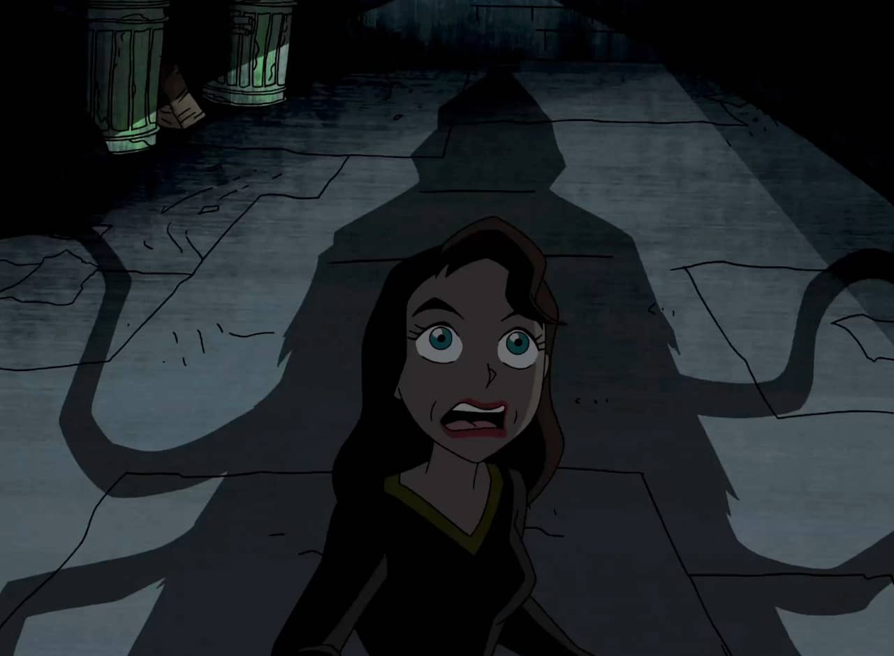 woman is frightened in the shadow of a hooded figure with four tentacles