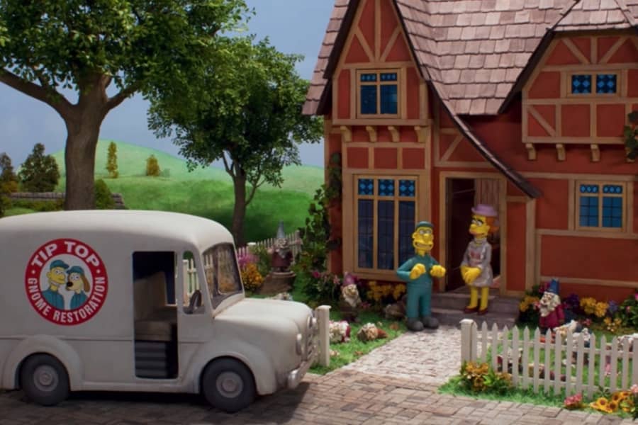 Willis talks with a woman at her home, his van “Tip Top Gnome Restoration” is parked out front