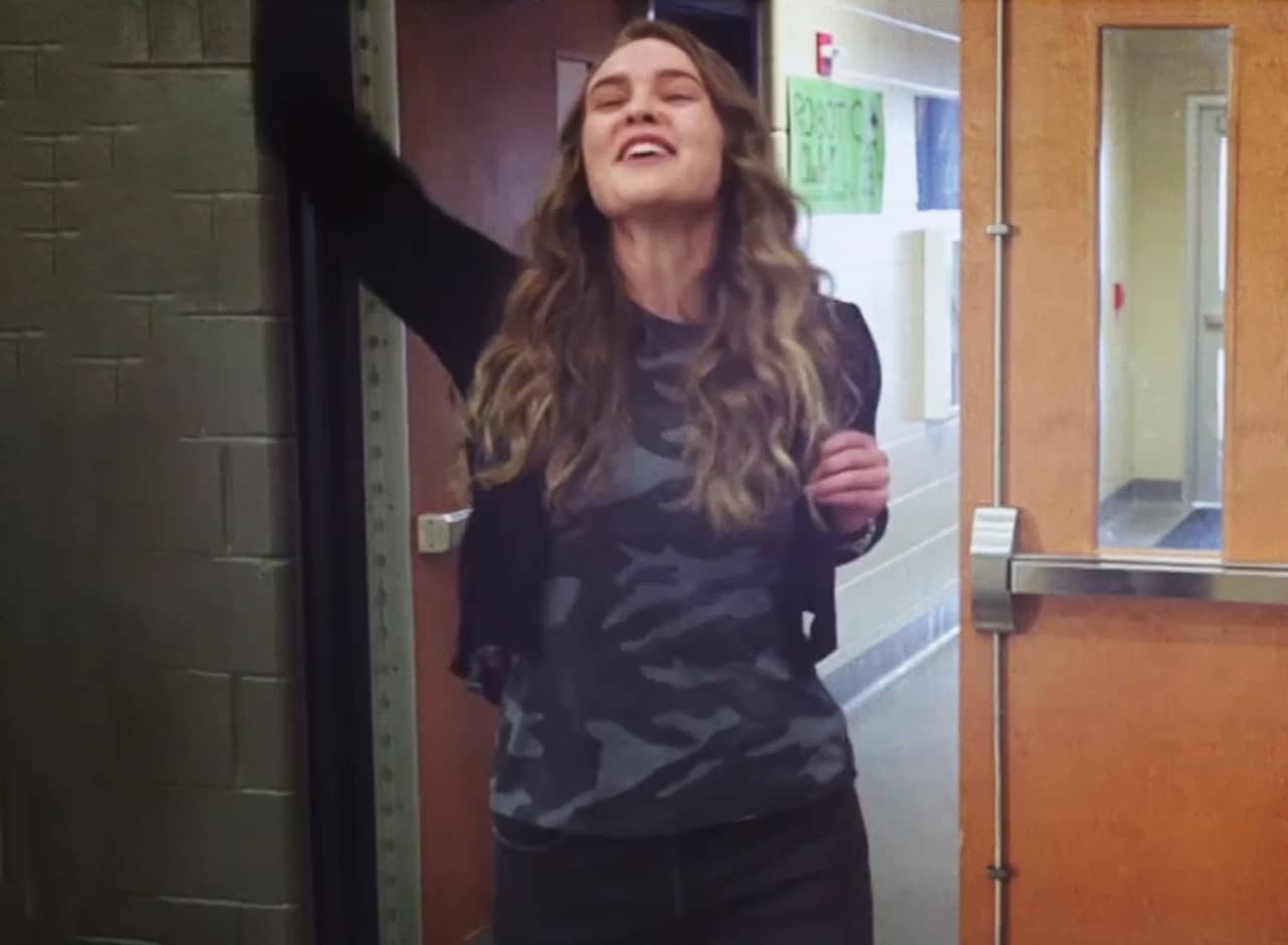 teen girl waving at her friends