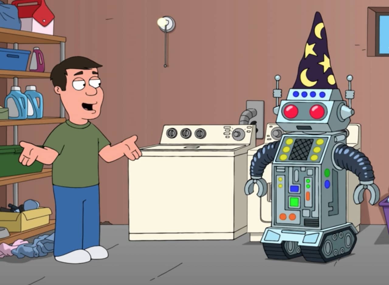 a man and a robot with a wizard hat talk next to a washing machine