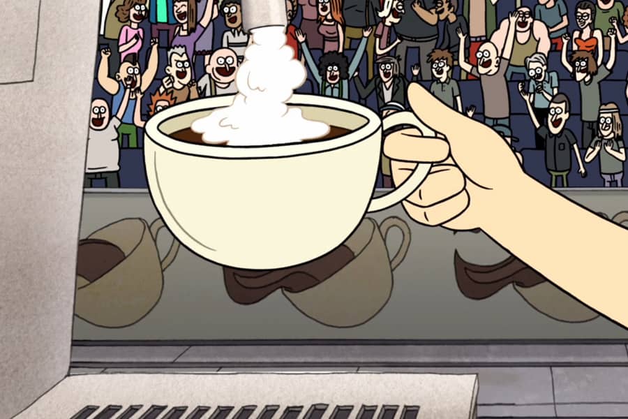 a hand holds a coffee cup under a milk frother