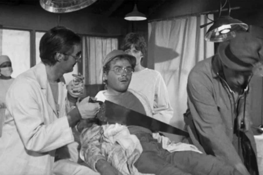 patient waking up as a doctor saws him in half