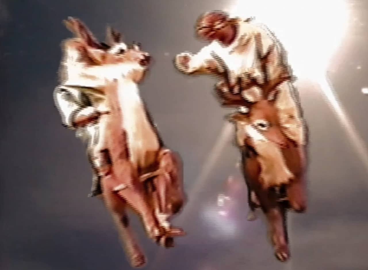 two men riding reindeer, they are obviously little models