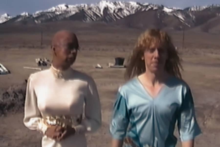 Crissop and Donaho walking with mountains behind
