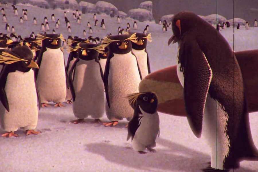 Big Z speaks with a kid penguin