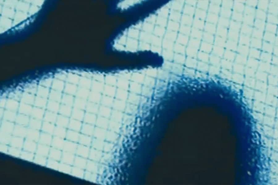 fuzzy sillhouette of a person’s head and hand pressed against a glass door